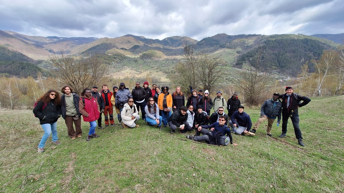 The Blended Intensive Programme cohort standing on a hillside in the Vrancea region, Romania